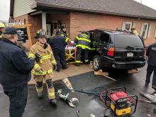 Rescue crews work to remove Sally Johnson from her SUV after it crashed into the former offices of Dr. Jose Derr. (Press Enterprise/Jimmy May)