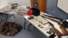 A drug raid early Friday led to a seizure of 34 pounds of marijuana along with $30,975 and several guns seen here at Town Police headquarters. (Press Enterprise/Leon Bogdan)