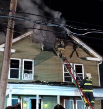 Firefighters attempt to knock down a fire on the second floor of 465 W. Mahoning St. (Press Enterprise/Leon Bogdan)