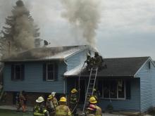 Smoke pours from the roof of 125 Trump Road in Valley Township. (Press Enterprise/Chris Krepich)