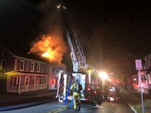 Press Enterprise/Susan Schwartz A Danville firefighter prepares an aerial unit to fight the blaze at 210 Bloom Street early Sunday morning.