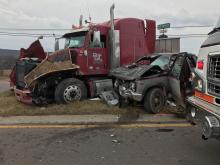A tractor trailer and a pickup truck rest in the grassy median of Route 54 after they collided on the road, near the I-80 interchange Friday morning. (Press Enterprise/Chris Krepich)
