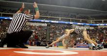 Southern Columbia’s Jaret Lane, right, escapes from the control of Reynolds’ Beau Bayless to take a one-point lead in the third period of the 106-pound semifinal match Friday night at the PIAA Class AA State Wrestling Championships at the Giant Center in Hershey. Lane won 3-0 and will wrestle for the gold Saturday afternoon. (Press Enterprise/Jimmy May)