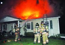 Firefighters battle a blaze at 44 Slate Road in Madison Township Saturday night.