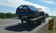 A car driven by the suspect in an armed robbery is towed from the eastbound lane of Interstate 80 Monday morning. (Press Enterprise/Julye Wemple)