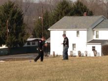 Officers stand near what they say was an actively brewing meth bottle in a field in Catawissa. (Press Enterprise/Kristin Baver)