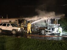 Press Enterprise/Susan Schwartz Summerhill firefighters Robert Youlls, left, and Randy Remphrey, right, spray foam to douse smoldering hot spots on the trailer owned by Wilberto and Kathy Rosario early Monday morning.