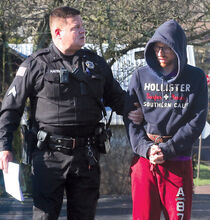 Cpl. Jason Hayes leads Nathan Roeder of Catawissa into District Judge Craig Long's office on Friday to be arraigned on charges of arson. (Press Enterprise/M.J. Mahon)