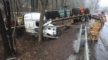 A tractor trailer sits jack knifed over the embankment along Route 42 in Eyers Grove Wednesday afternoon. (Press Enterprise/Keith Haupt)