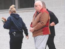 (Press Enterprise/Keith Haupt) Dave Shields, retired Berwick Elementary School teacher is taken from Shickshinny State Police barracks Thursday afternoon by two agents from the Attorney General’s office.