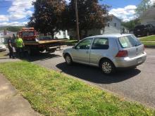 Briar Creek Township Officer Shawn Young talks with Welsh's Towing driver Jim Hess before Hess hauls away the car that led police on a slow-speed chase ending in Berwick Monday.