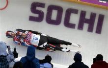 The doubles team of Christian Niccum and Jayson Terdiman of the United States speed down the track on their first run during the men's doubles luge at the 2014 Winter Olympics, Wednesday, Feb. 12, 2014, in Krasnaya Polyana, Russia. (AP Photo/Natacha Pisarenko)