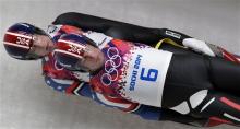 The doubles team of Christian Niccum and Jayson Terdiman of the United States speed down the track in their final run during the men's doubles luge at the 2014 Winter Olympics, Wednesday, in Krasnaya Polyana, Russia. (AP Photo/Michael Sohn)