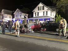 Press Enterprise/Susan Schwartz Tow truck driver Ryan Lynn balances on top of an overturned Jeep Patriot as he prepares to flip it right-side up after an early morning crash in Bloomsburg.