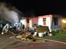 A trailer at 7465 Columbia Blvd., Lot 19, burns during an early-morning fire. (Press Enterprise/Peter Kendron)