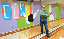 Bob Davenport stands in one of the lanes of the six-lane bowling alley in the basement of the Berwick Elks Lodge Thursday morning. The artwork behind his was done by art students from Berwick High School. The lanes are open Sunday’s from noon to 9:00 p.m.