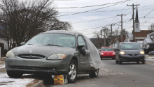 A damaged green Ford sedan remains on Orange Street, a month after it was struck. An alleged drunken driver struck it while two women were unloading groceries, police say. (Press Enterprise/Dave Kennedy)