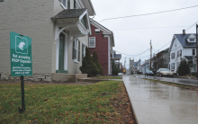 A sign protesting the leaving of dog poop is posted in the yard at 233 W. Third St., Bloomsburg, Thursday afternoon. (Press Enterprise/Jimmy May)