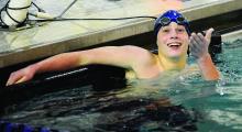 Berwick's Mike Rehrig reacts to his time being tied for first place on the scoreboard after finishing the 50 freestyle during Tuesday afternoon's meet against Wyoming Seminary at Berwick.