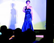 Danville High School student Laura Gass models a previously worn blue gown