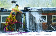 Firefighters work to douse a blaze after it broke out at a home on Meadow Lane in Fishing Creek Township