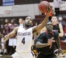 Bloomsburg University's Andrew Morgan, left, catches a three-quarter court inbound pass with one hand while being chased down the court by East Stroudsburg University's Jamal Nwaniemeka during the first half of Wednesday night's game at Bloomsburg. 