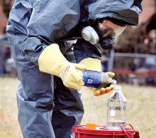 State Police forensic scientist Rebecca Patrick separates the liquid from the solids in the one-pot bottle following a Methamphetamine bust in Catawissa on Monday. 