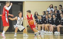 Mount Carmel's Ben Scicchitano, left, sets a pick for Central Columbia's Joey Eckenrode, center, while Mount Carmel's Zack Toculoski heads to the inside during the first quarter of Tuesday night's game at Central. 