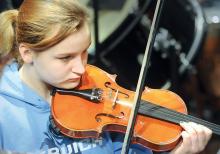 Jordan Greshko rehearses the Academic Festival Overture with the rest of the Pennsylvania Music Educator's Association District 8 Orchestra members Friday morning. 