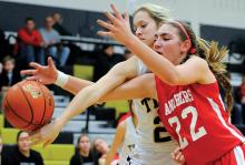 Southern Columbia's Avory Pantalone, left, and Bloomsburg's Amelia Davis reach for the rebound, which went out of bounds off of Pantalone during the first quarter of Monday night's game at Southern. 