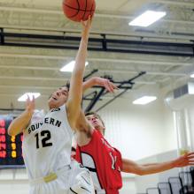 Southern Columbia's Walker Palacz, left, draws a foul from Mount Carmel's Zack Tocyloski while putting up a shot in the second quarter Thursday night at Southern.