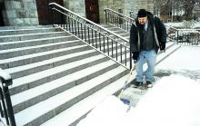 Bill Laudermilch shovels the snow from the steps of the Wesley United Methodist Church on Market Street in Bloomsburg Saturday morning.