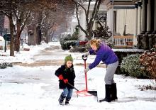 Cole Hendricks, 4, helps his mom, Shelly Hendricks, shovel snow in front of their West Fifth Street home in Bloomsburg on Friday morning. 