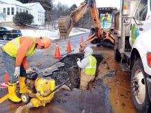 A United Water crew works to repair a break in a six-inch main on East First Street in Bloomsburg on Sunday afternoon. 