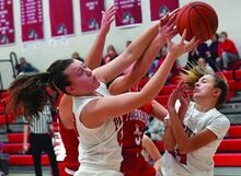 Press Enterprise/Jimmy May Bloomsburg’s Cassie McGinley, foreground, pulls in the rebound over, from left, Mount Carmel’s Anna Grace Renno, Hannah Fourspring and Bloomsburg’s Haili Bower during the first quarter of Wednesday night’s game at Bloomsburg. 