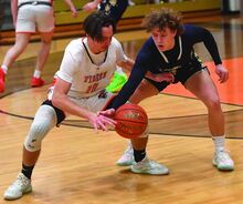 Press Enterprise/Jimmy May Northwest’s Ryan Miner, right, takes control of the ball from Benton’s Landon Kester during the first quarter of Tuesday night’s game at Benton.