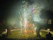 Dave Stabley, right, and Richard Kahn light the sparklers that started the fire they used to destroy the 7-foot sculpture that was the centerpiece of the New Year Burn Sunday night.