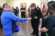 Daryn Kingston recieving a certificate recognizing him as a life saver this week. The 17-year-old boy used his belt as a makeshift tourniquet to save his father’s life in December. 