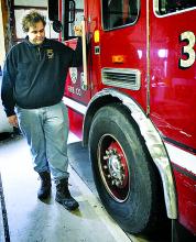 Aristes Fire Company Lt. Matthew Yeager looks over damage to the company’s pumper tanker truck at the fire hall on Friday. 