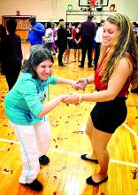 Bloomsburg High School life skills student Kelsey Wingate, left, dances with Berwick High School senior and peer tutor Brittany Fisher during the 13th annual Life Skills Valentine Dance at Berwick High School on Wednesday.