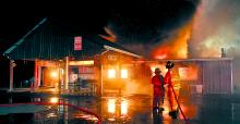 Firefighters try to contain flames as Creekside Family Restaurant in Orange Township is destroyed by fire early Sunday morning.