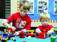 Jansen Sarisky, left, 6, Bloomsburg, and Rylan Kiersch, 3, Danville, play with toy trains during the annual Columbia Mall Children's Fair.