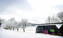 A tractor is parked out of the elements in a shed in Mill Grove