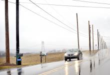 Replacement utility poles stand with existing poles along Route 487 near Rohrbach Farms