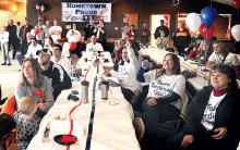Friends and neighbors gathered at Reliance fire hall in Berwick cheer as they watch Berwick’s Jason Terdiman and his luge partner Christian Niccum compete in the Winter Olympics at Sochi, Russia on Wednesday morning.