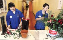 Ashley Moyere, left, and classmate Alli Shick, make up bouquets with roses Sunday afternoon as part of a demonstration for the Columbia-Montour Vocational Technical School's annual Open House. The two freshman are taking classes in horticulture. 