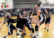 The members of Central Columbia's girls basketball team run together on the court as they celebrate their win over Warrior Run Wednesday night in Danville sending them to the District 4 class AA final. 