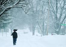 Ravon Hemphill walks up Catherine Street in Bloomsburg after traveling to homes of friends and family to help them dig out Saturday.