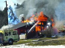 Press Enterprise/Jimmy May Firefighters work to get water on a fire consuming a barn at 118 Hollow Road in Catawissa Township Wednesday afternoon