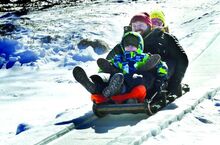 Press Enterprise/Bill Hughes The Campbell family from Reading slides down Lake Avenue and out on to Eagles Mere Lake during the Eagles Mere Fire Company’s toboggan run on Saturday afternoon. From front to back are Clayton, 7, his dad Chad and his mom Cat. 